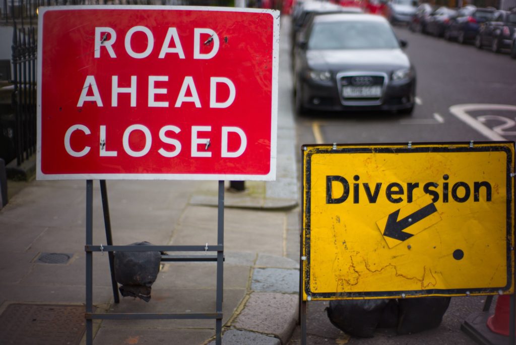 Road closed ahead and Diversion signs