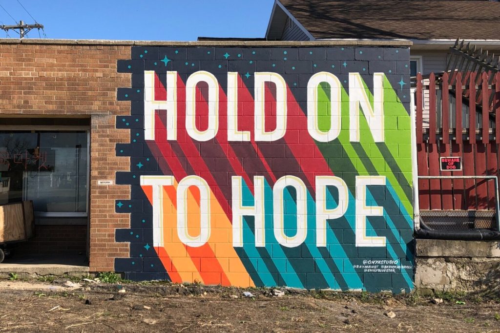 Mural reading Hold on to Hope on Asian grocery store.